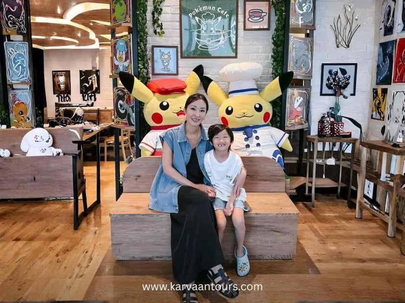 Family posing with Chef Pikachu at Pokemon Cafe Japan