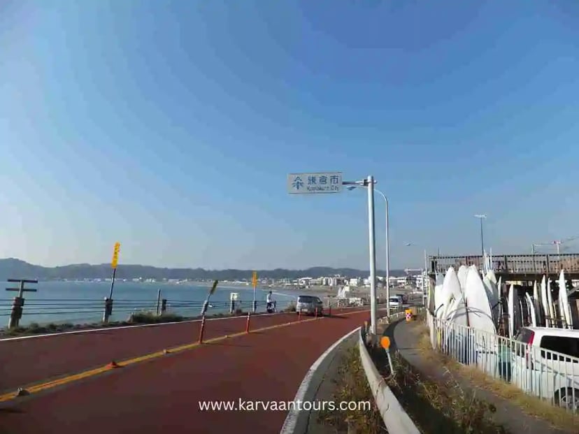 Seaside road with ocean view and vehicles along the Kamakura coastline in Japan