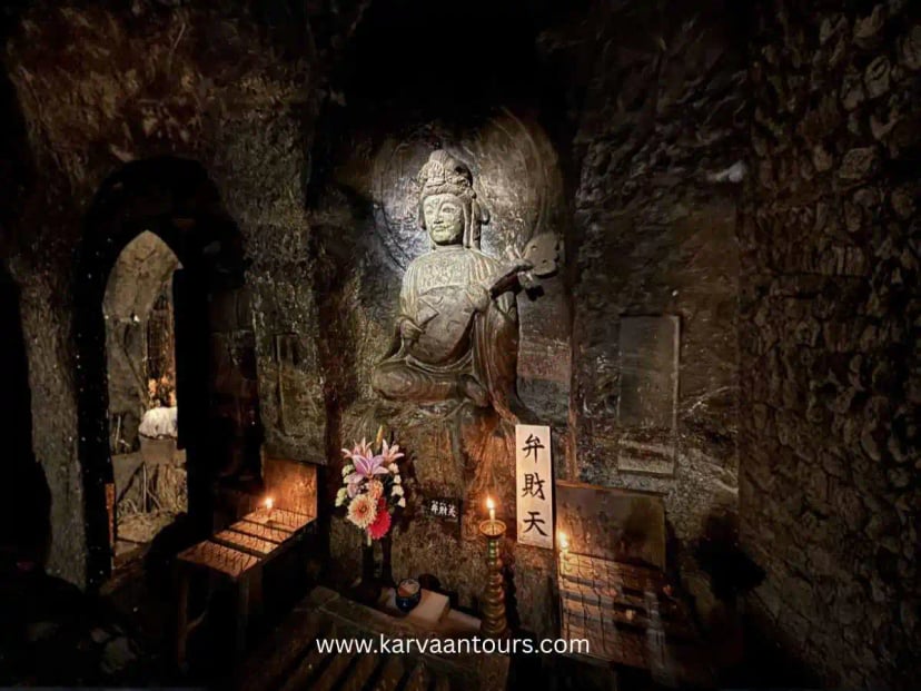 Buddhist statue inside a candle-lit cave shrine at Hasedera Temple in Kamakura