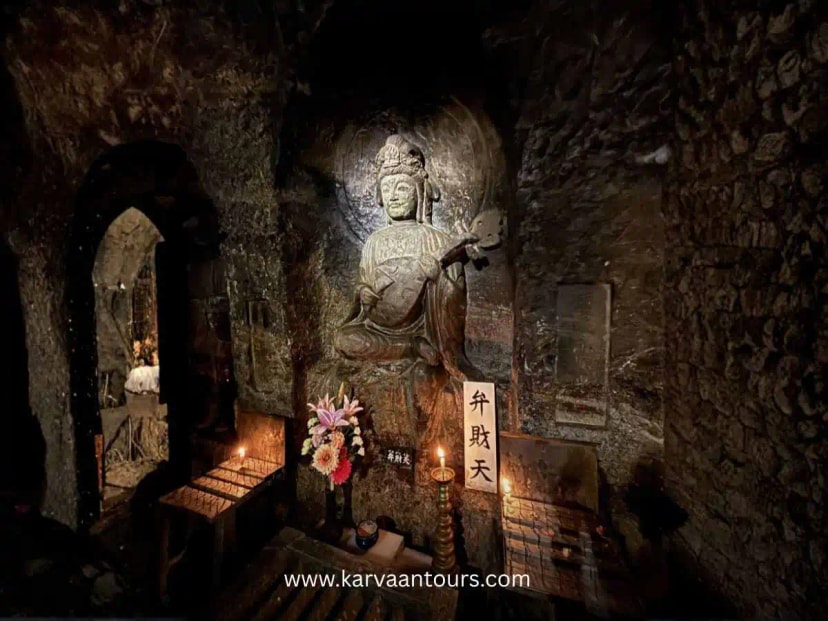 Buddhist statue inside a candle-lit cave shrine at Hasedera Temple in Kamakura