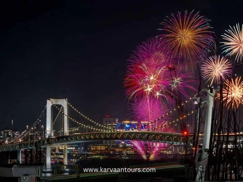 Fireworks lighting up the sky above Rainbow Bridge in Odaiba Tokyo at night