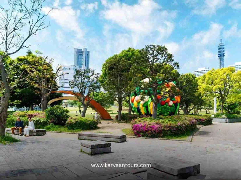 Colorful sculpture and landscaped park area in Minato Mirai with Yokohama skyline in the background