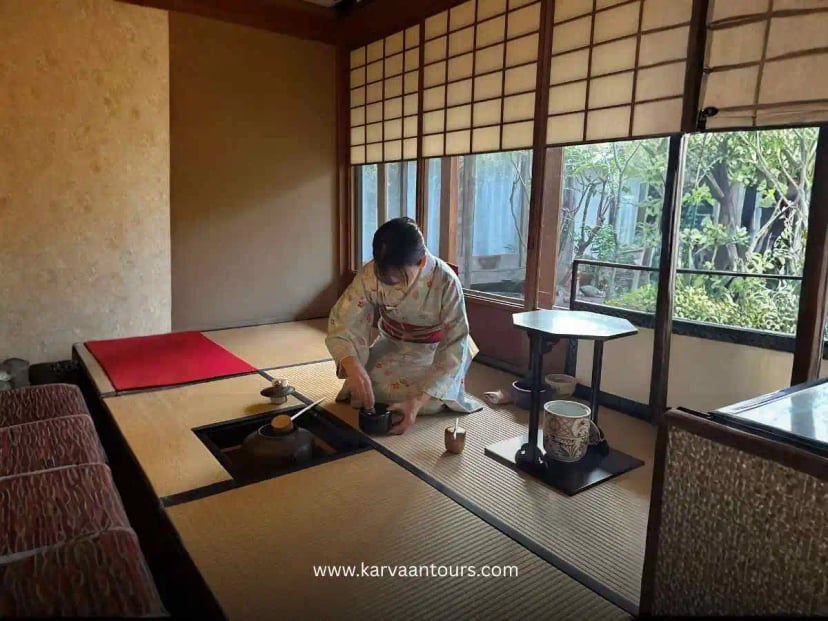 Traditional Japanese tatami living room with floor cushions and low table overlooking a garden through shoji windows