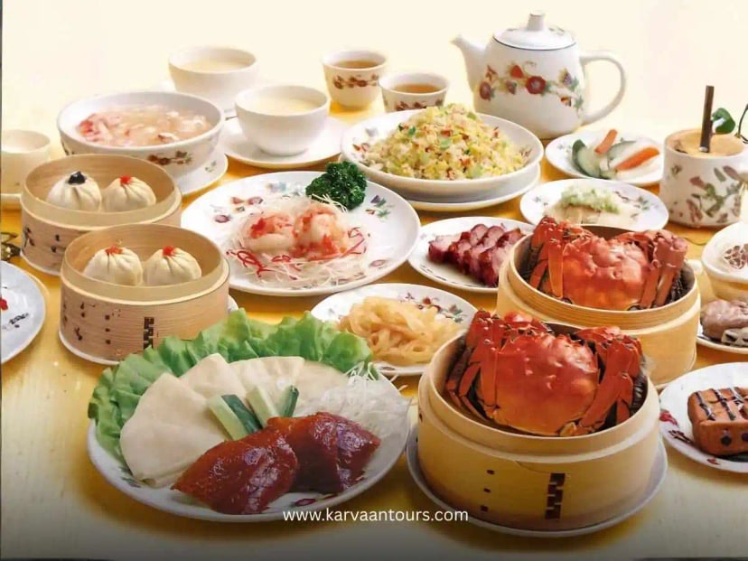 A table filled with Chinese dishes including dim sum, crab, tea, and side plates in Yokohama Chinatown