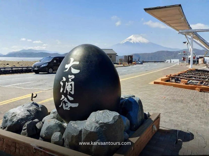 Black egg monument at Owakudani with Mount Fuji visible in the background on a clear day in Hakone