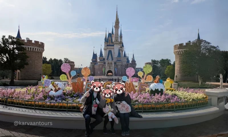 Family posing in front of Cinderella Castle at Tokyo Disneyland