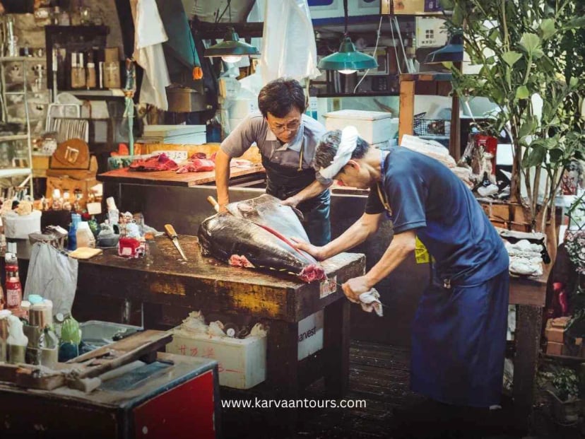 A skilled fishmonger at the Tsukiji market meticulously slicing a large piece of fresh tuna, highlighting the precision and tradition of Japanese fish preparation.