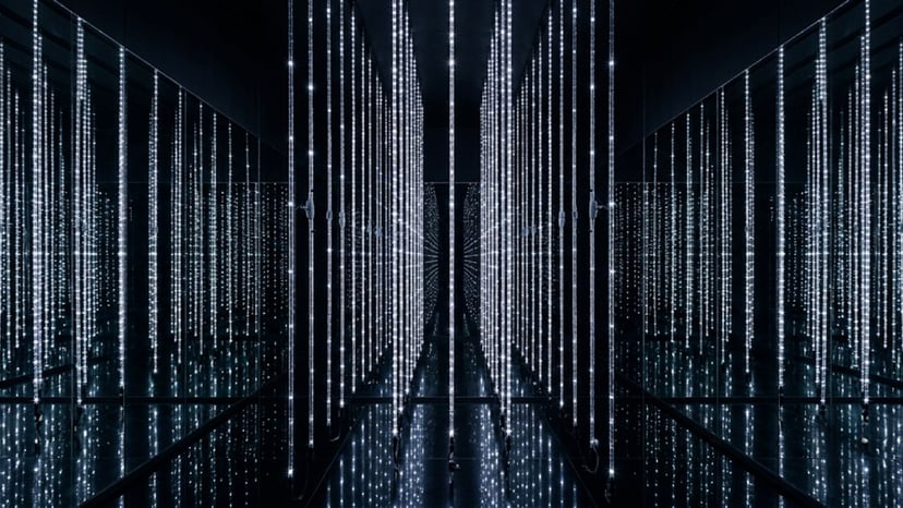 The Infinite Crystal Universe featuring thousands of vertical LED light strings creating an infinite mirror effect.