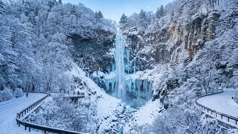 The breathtaking sight of Kegon Waterfall partially frozen into stunning blue ice formations in winter.