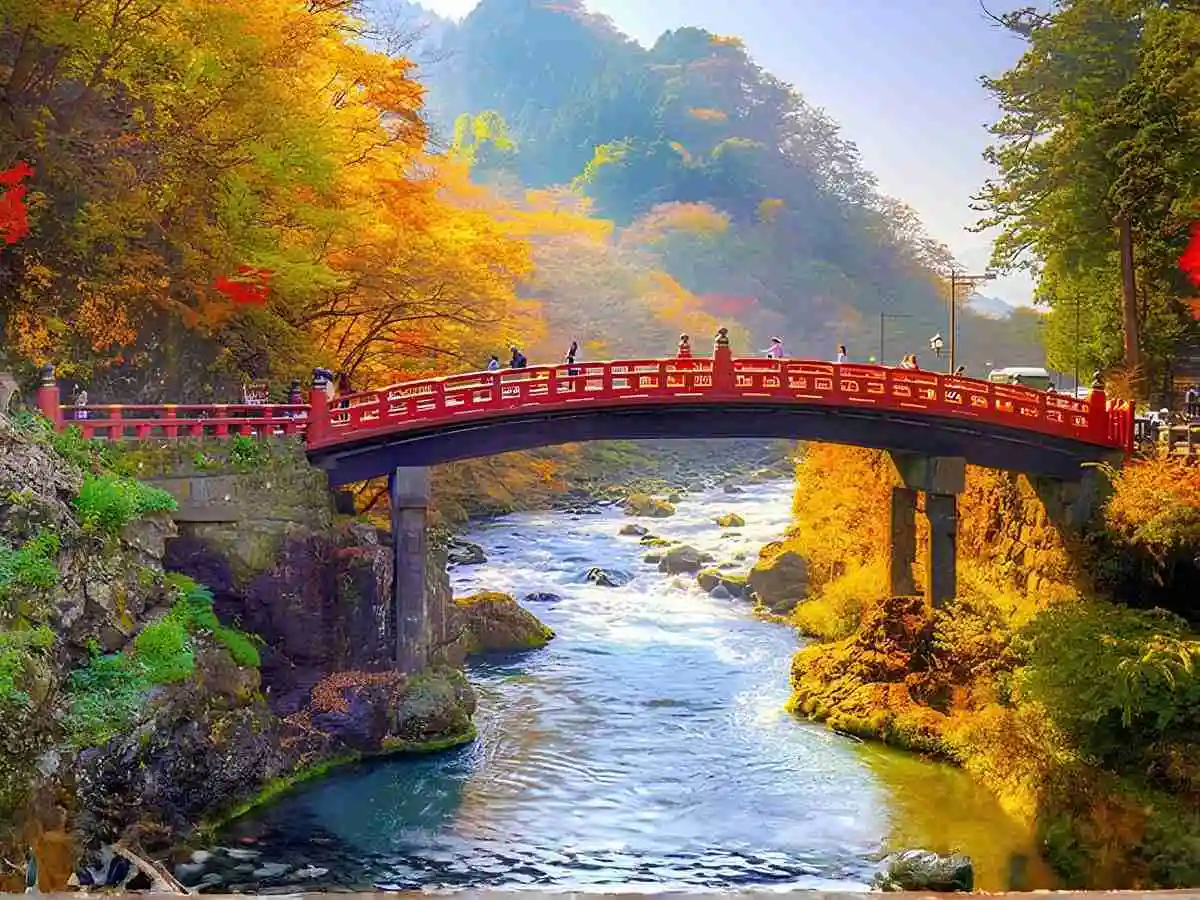 Sacred Shinkyo Bridge over Daiya River in Nikko surrounded by autumn colors